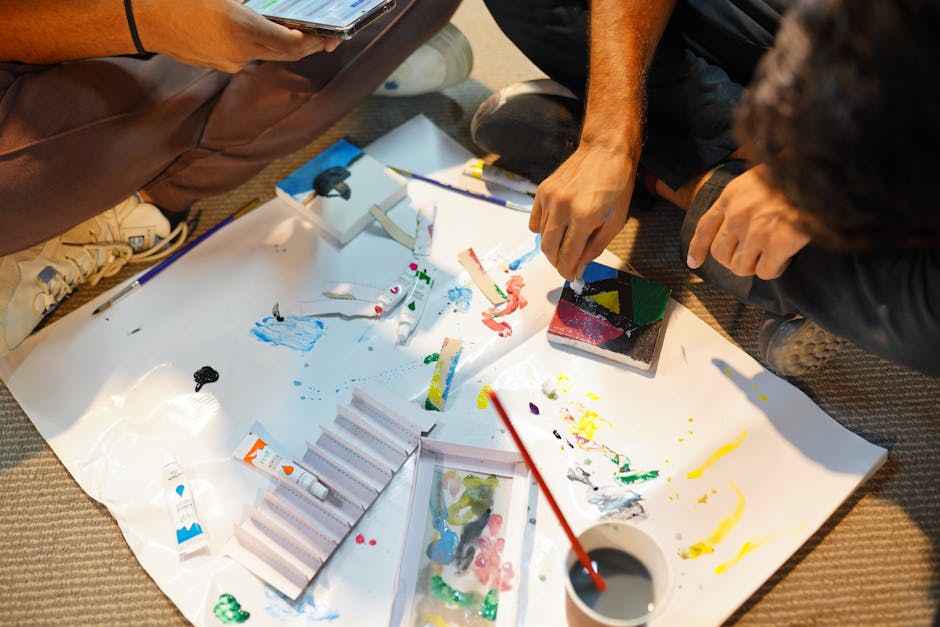 Adults engaged in a hands-on painting workshop, mixing colors and creating art indoors.