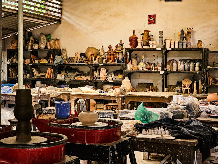 A diverse collection of pottery and tools in a bustling workshop. Perfect for art enthusiasts.